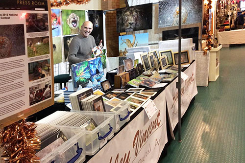 wildlife photographer Ashley Vincent at his event stand for an indoor event