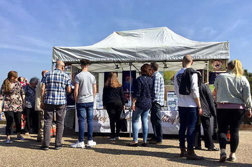 people looking at Ashley Vincent's picture display at Eastbourne's grand parade
