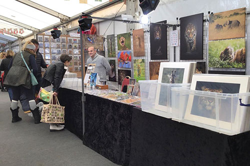 customers engaging with Ashley Vincent at his picture display gazebo at the Windsor Christmas Fair