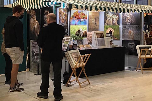 customers engaging with wildlife photographer ashley vincent at his stand Centre MK in Milton Keynes
